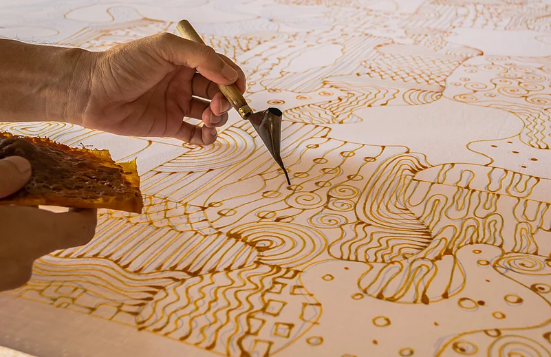 Painting with candles for a batik work